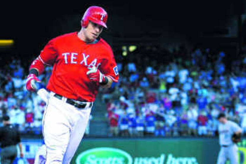  The Rangers' Josh Hamilton rounds the bases on his two-run homer in the second inning....
