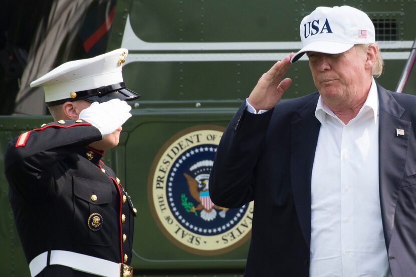 President Donald Trump walks from Marine One upon arrival Sunday on the South Lawn of the...