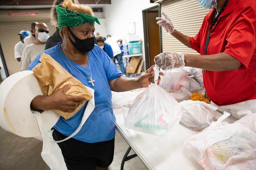 Tammy Ardmon (left) received a meal at Cornerstone Community Development Corp. in Dallas on...