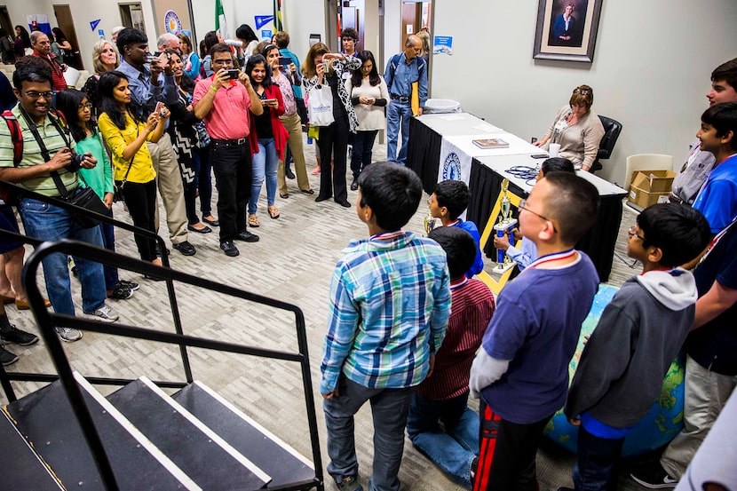  Parents take pictures of the top ten finalists during the National Geographic 2016 State...