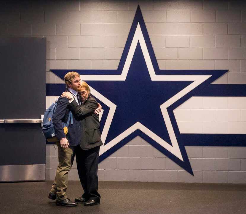 Dallas Cowboys wide receiver Cole Beasley hugs stadium security officer Sue Raagas as he...