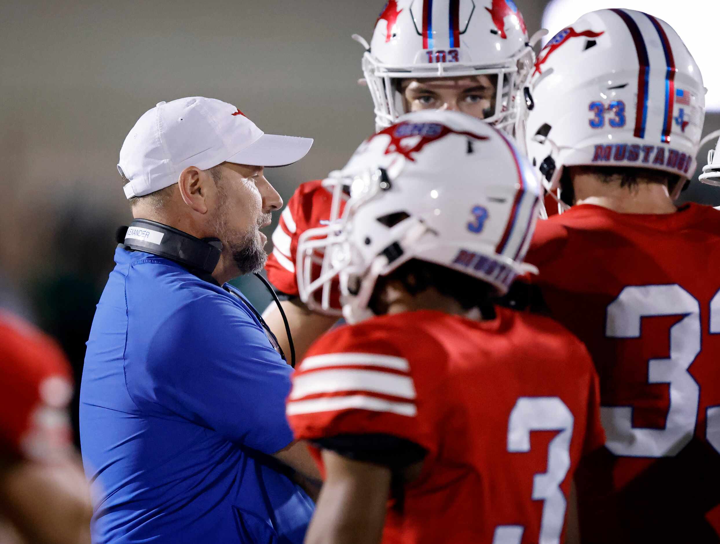 Grapevine head coach Mike Alexander gathers his players during a first half timeout against...