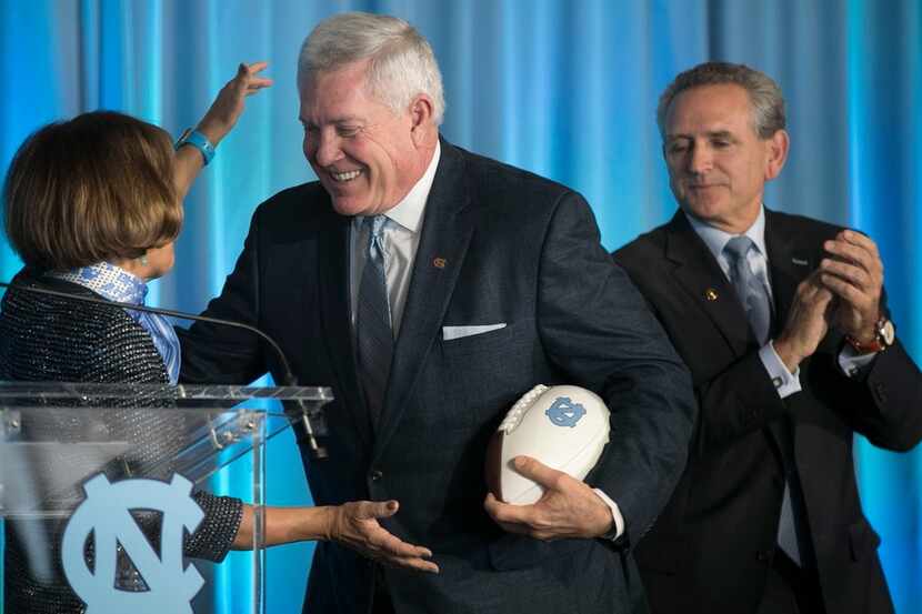 Mack Brown, center, is introduced by University of North Carolina Chancellor Carol Folt,...