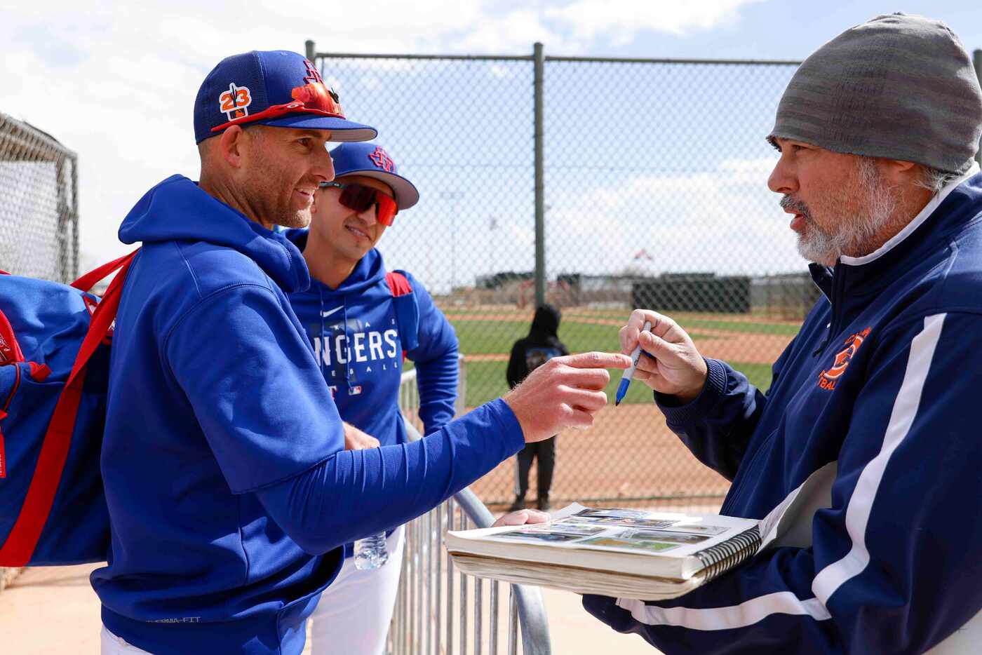 Texas Rangers outfielder Brad Miller, left, and infielder Mark Mathias, back, talks to Matt...