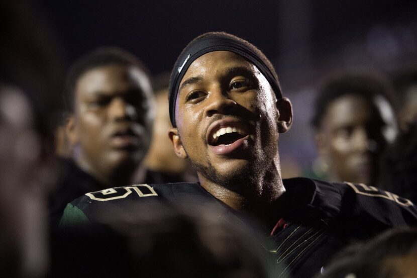 DeSoto junior defensive back Byron Hanspard Jr. (5) sings his school's alma mater after...