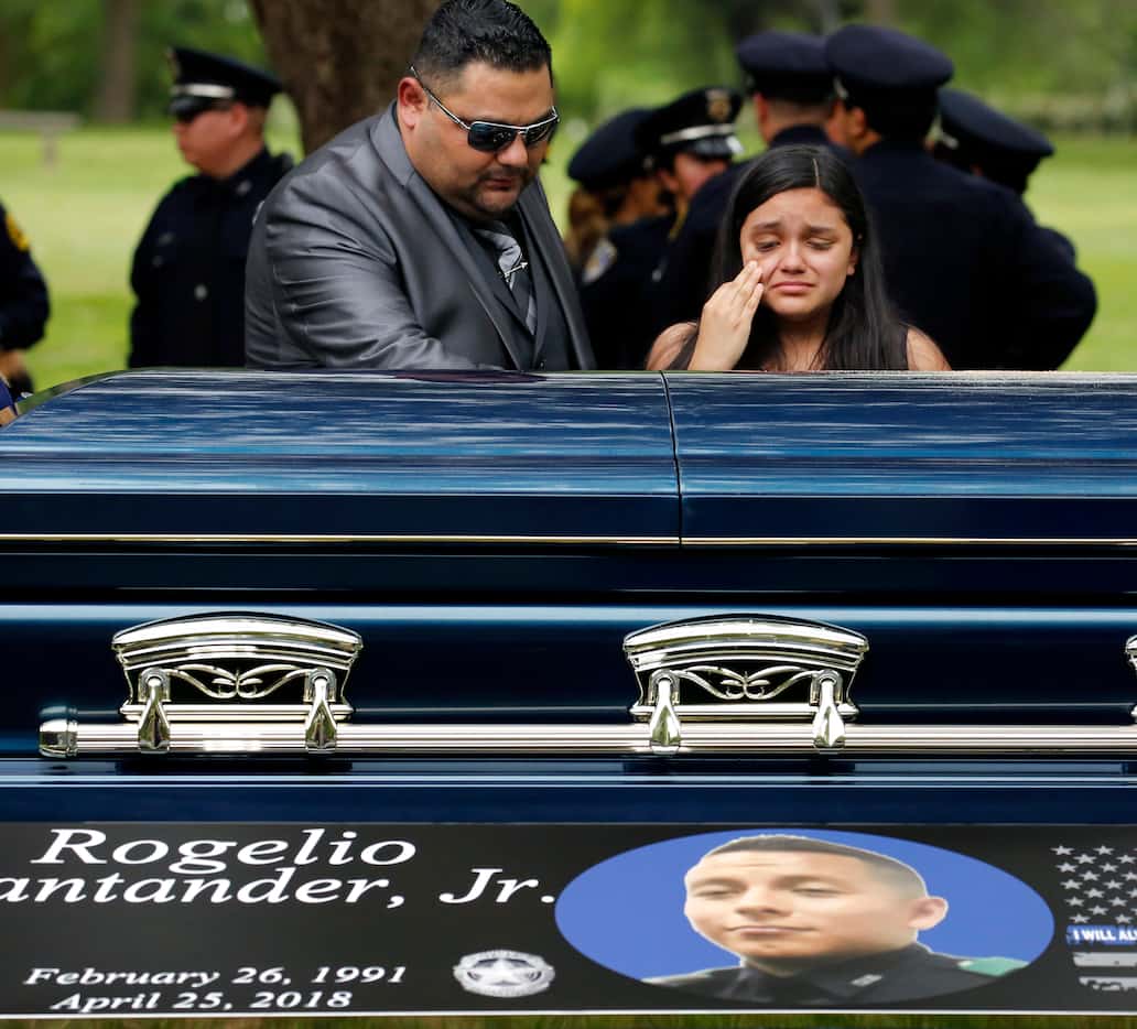 Family members of Dallas police officer Rogelio Santander, Jr., 27, pay their respects as...