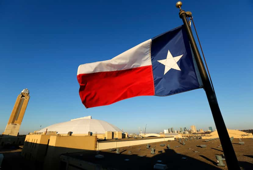 The Texas flag waves above the Pioneer Tower (from left), Will Rogers Memorial Coliseum and...