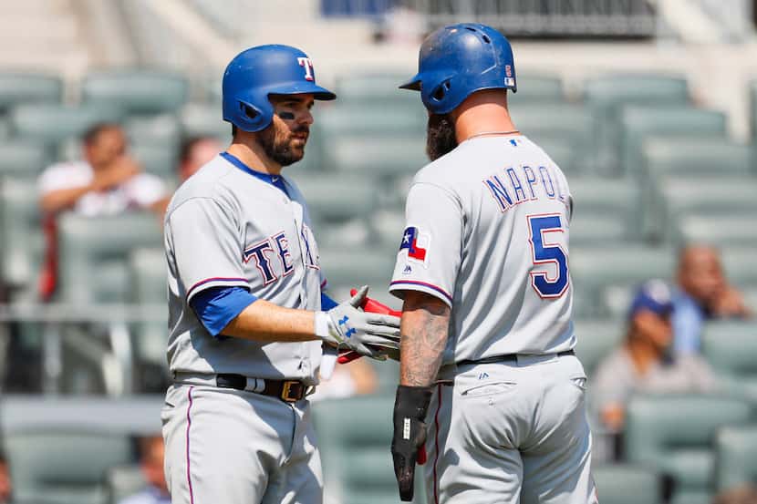 Texas Rangers' Brett Nicholas (6) and Mike Napoli (5) react after scoring in the fourth...