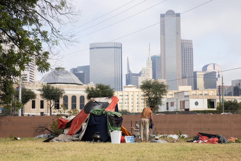 A man in encampment zone 3 sweeps his area on Tuesday, Sept. 17, 2024. The Street to Home...