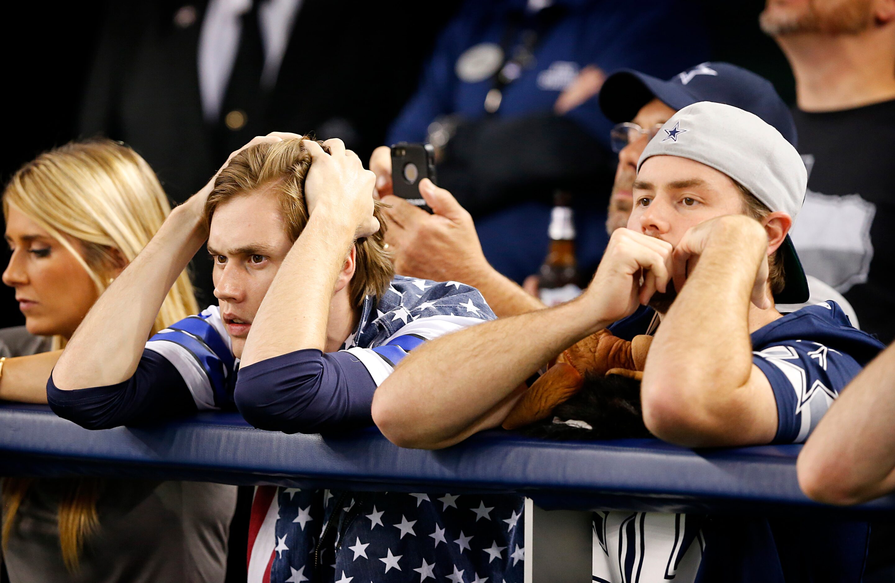 Dallas Cowboys fans react after Dallas Cowboys quarterback Tony Romo (9) went of of the game...