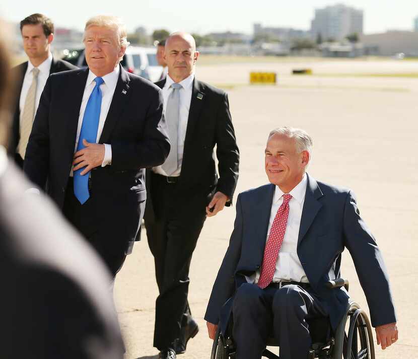 President Donald Trump and Texas governor Greg Abbott greet supporters after Trump arrived...