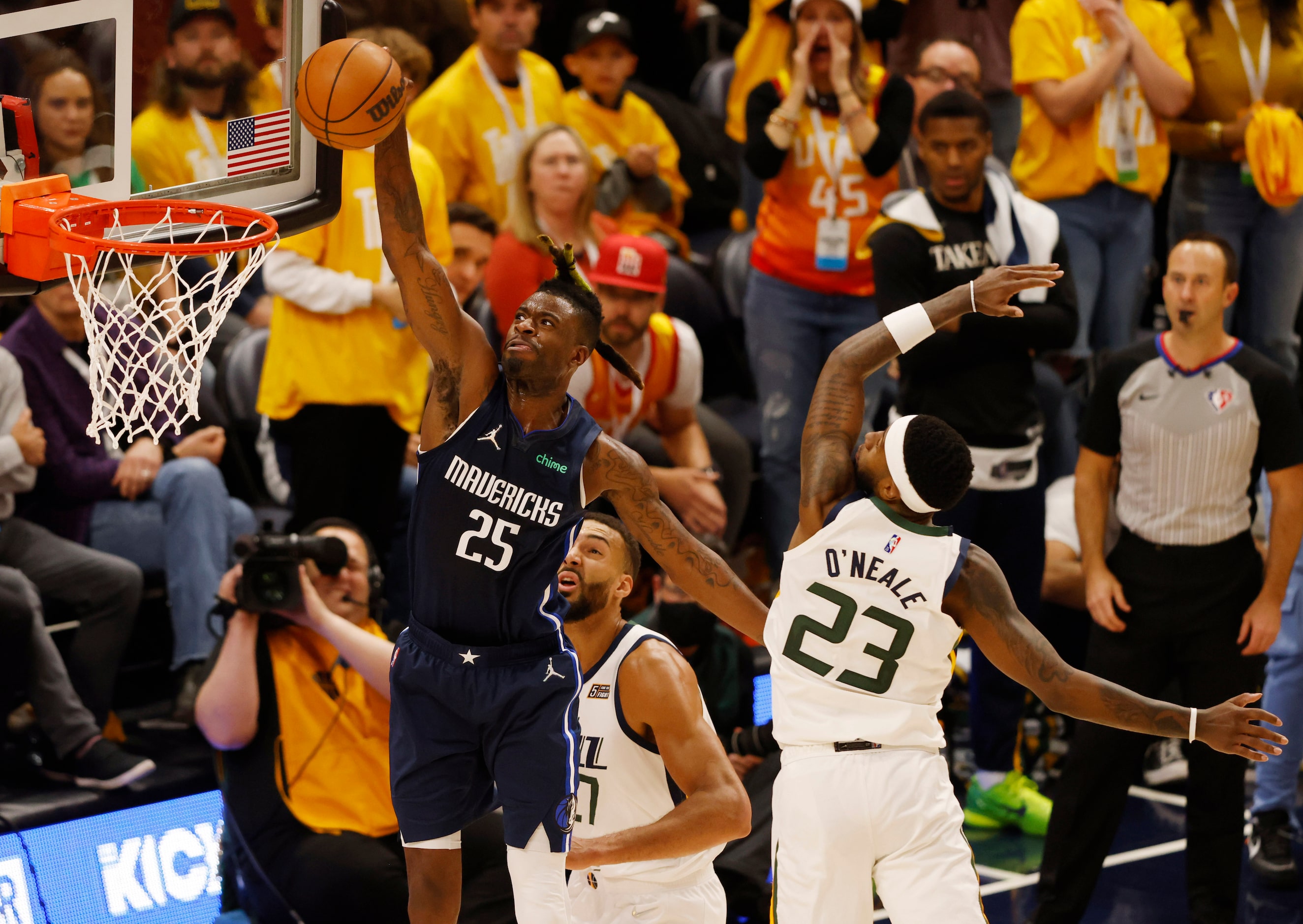 Dallas Mavericks forward Reggie Bullock (25) dunks the ball as Utah Jazz center Rudy Gobert...