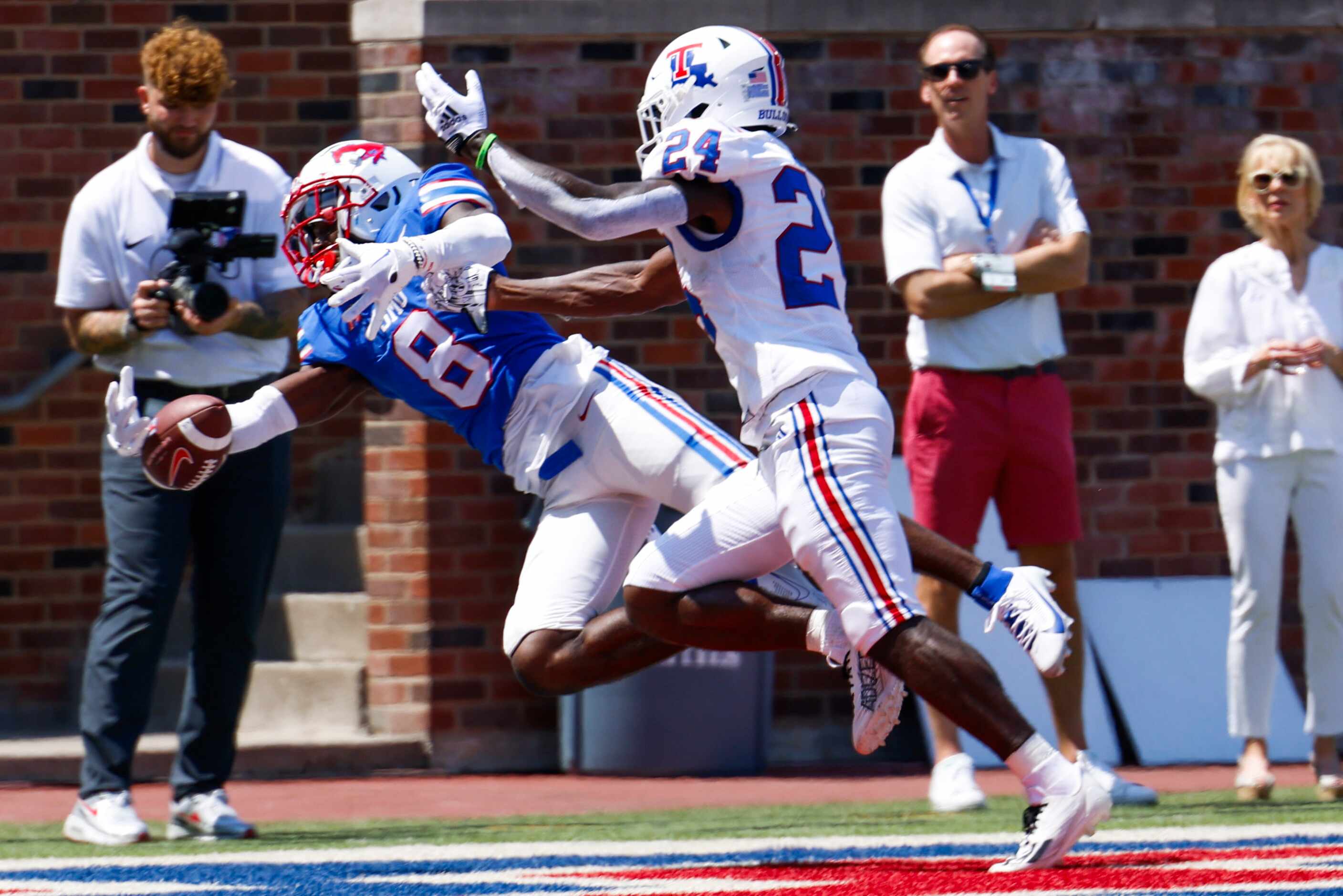 Southern Methodist linebacker JaQwondis Burns (left) misses to score a touchdown past...