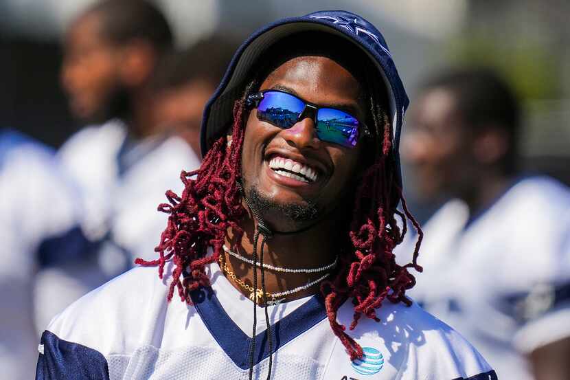 Dallas Cowboys wide receiver CeeDee Lamb laughs with teammates during a training camp...