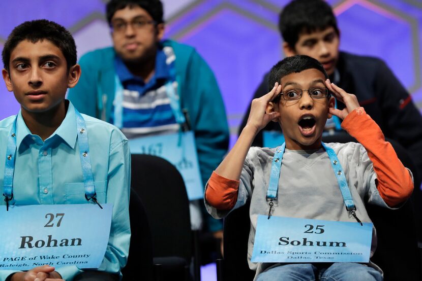 Sohum Sukhatankar, 11, of Allen, Texas, right, takes a moment during a break in competition...