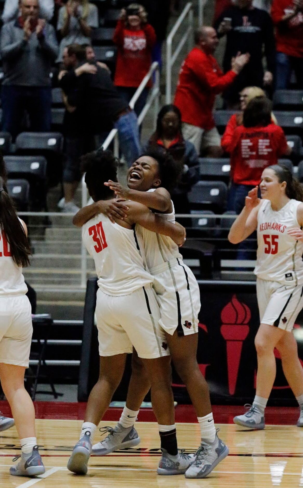 Liberty High School guard Jazzy Owens-Barnett (30) embraces Liberty High School guard...