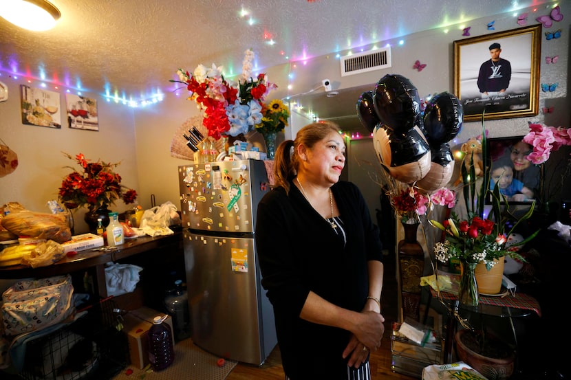 Lilian Navarrete stands by a portrait of her son Jose Fernando Chacon Navarrete in her...