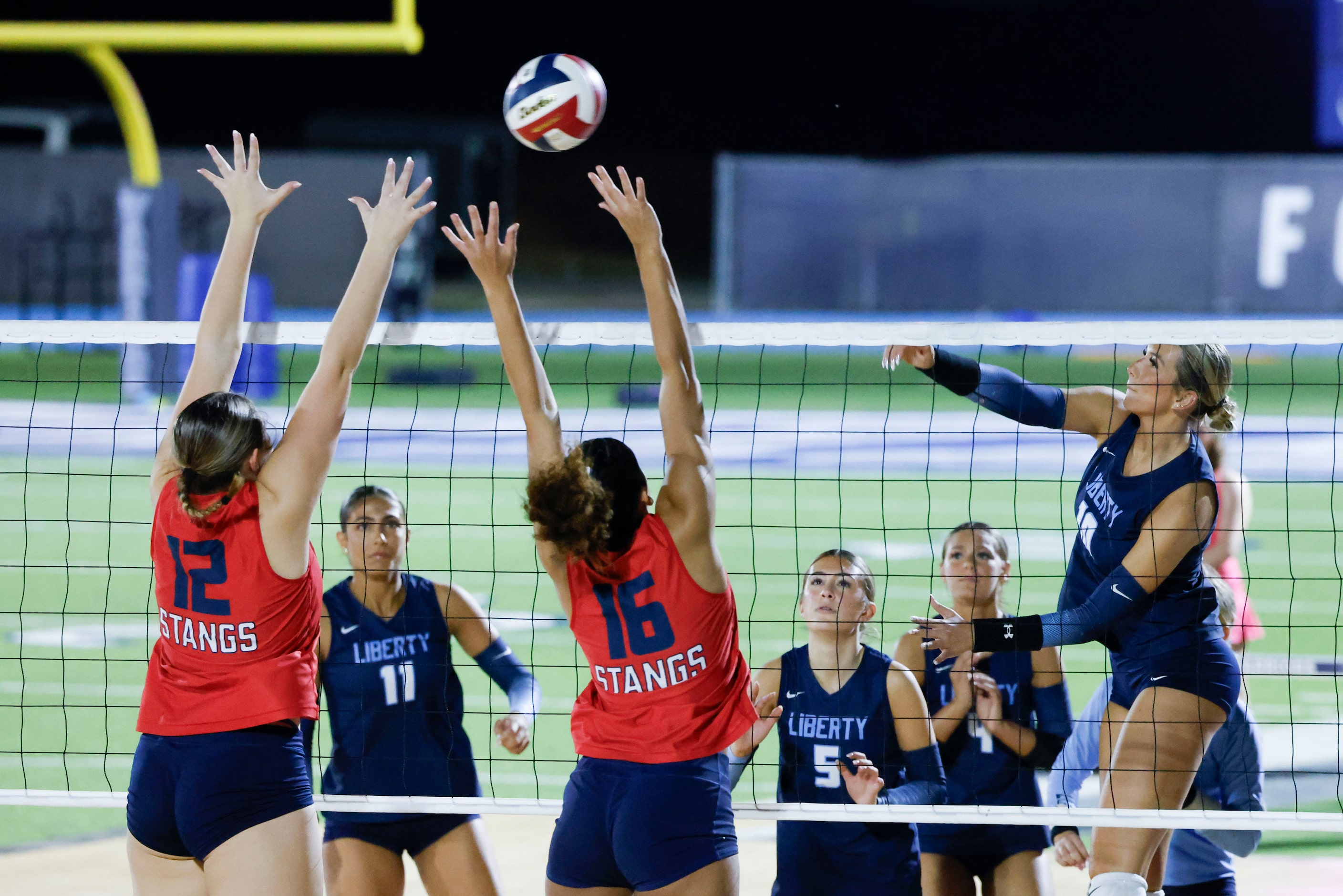 Grapevine High’s Sophie Baker (12) and Alena Curtis (16) reach to block as Liberty Christian...