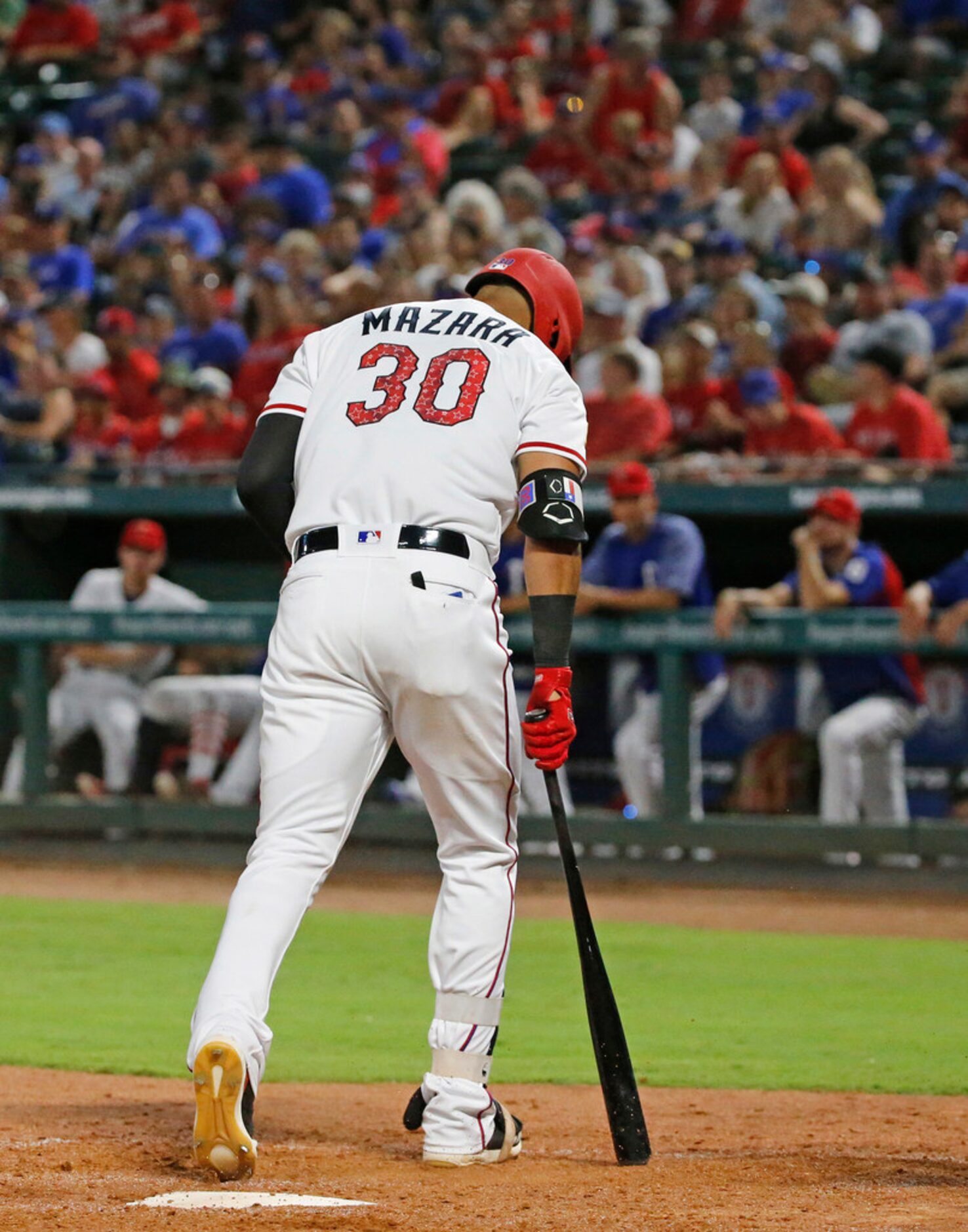 Texas Rangers Nomar Mazara (30) walks back to the dugout after striking out in the eighth...