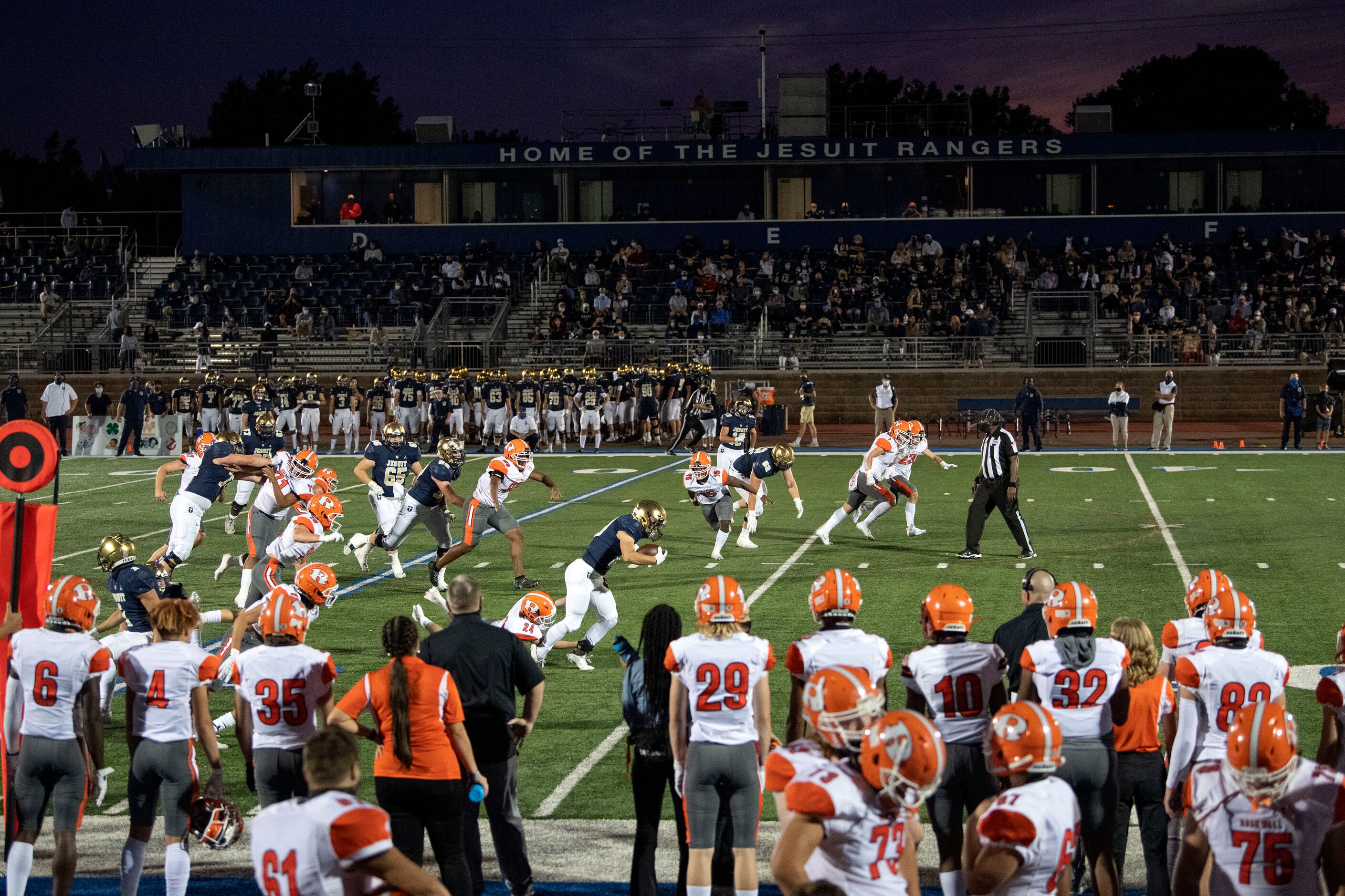 Jesuit senior running back Charlie Clements (10) runs past Rockwall junior defensive back...