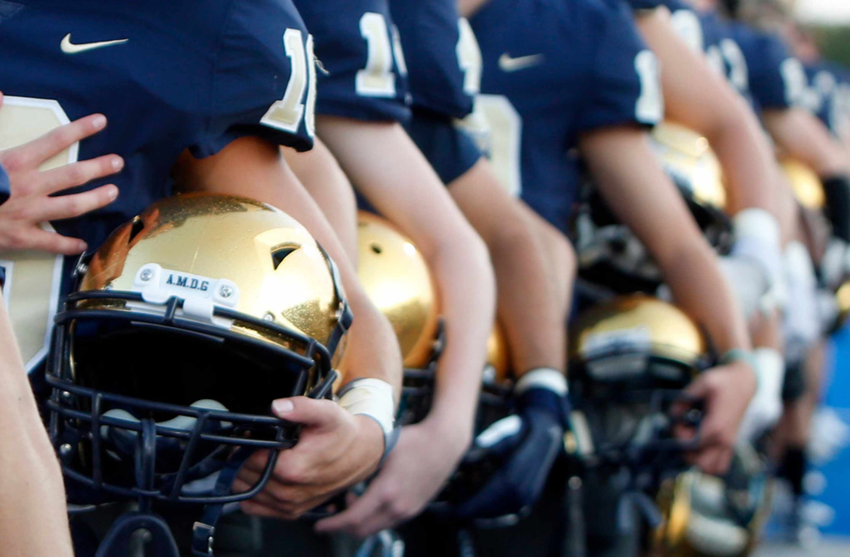 Members of the Jesuit Rangers pause for the playing of the national anthem prior to the...