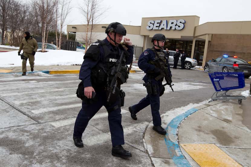 Police move in from a parking lot to the mall in Columbia after reports of a multiple...