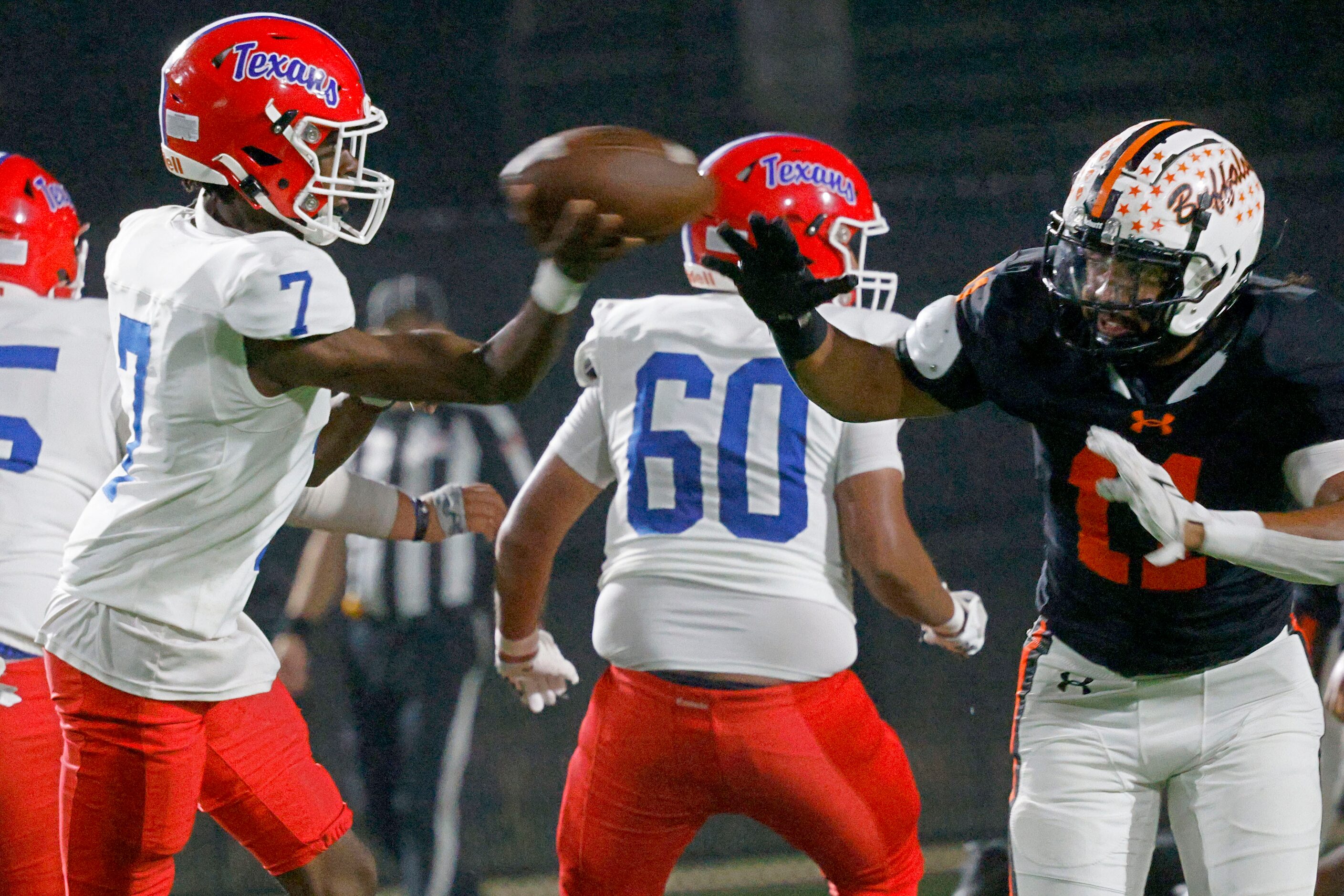 Sam Houston's Ken Jones (7) passes under pressure from Haltom's Damien Wayne (11) in the...