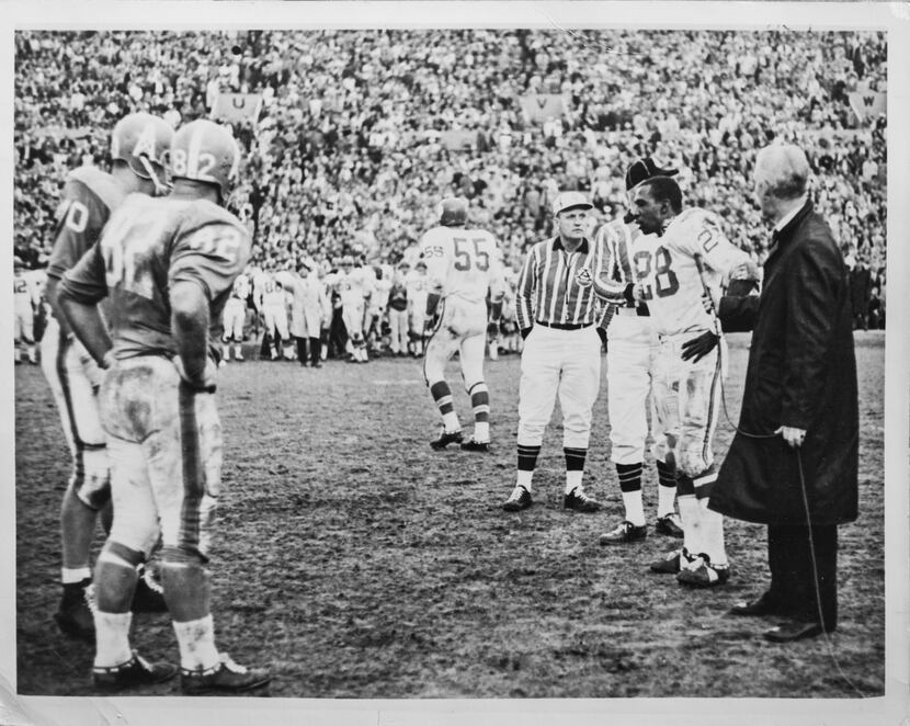 ABC-TV announcer Jack Buck holds the microphone at the coin flip following regulation play...