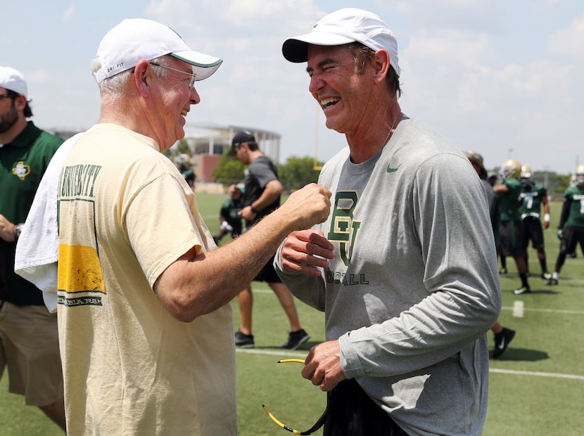 FILE - In this Aug. 5, 2014, file photo,Baylor University President Ken Starr, left, jokes...