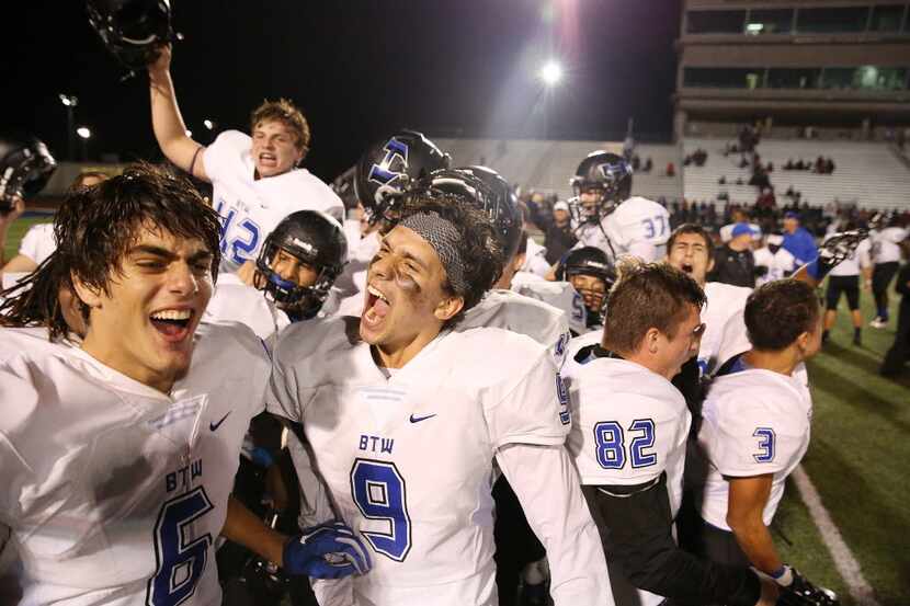 Hebron players celebrate after earning a spot in the playoffs following a high school...