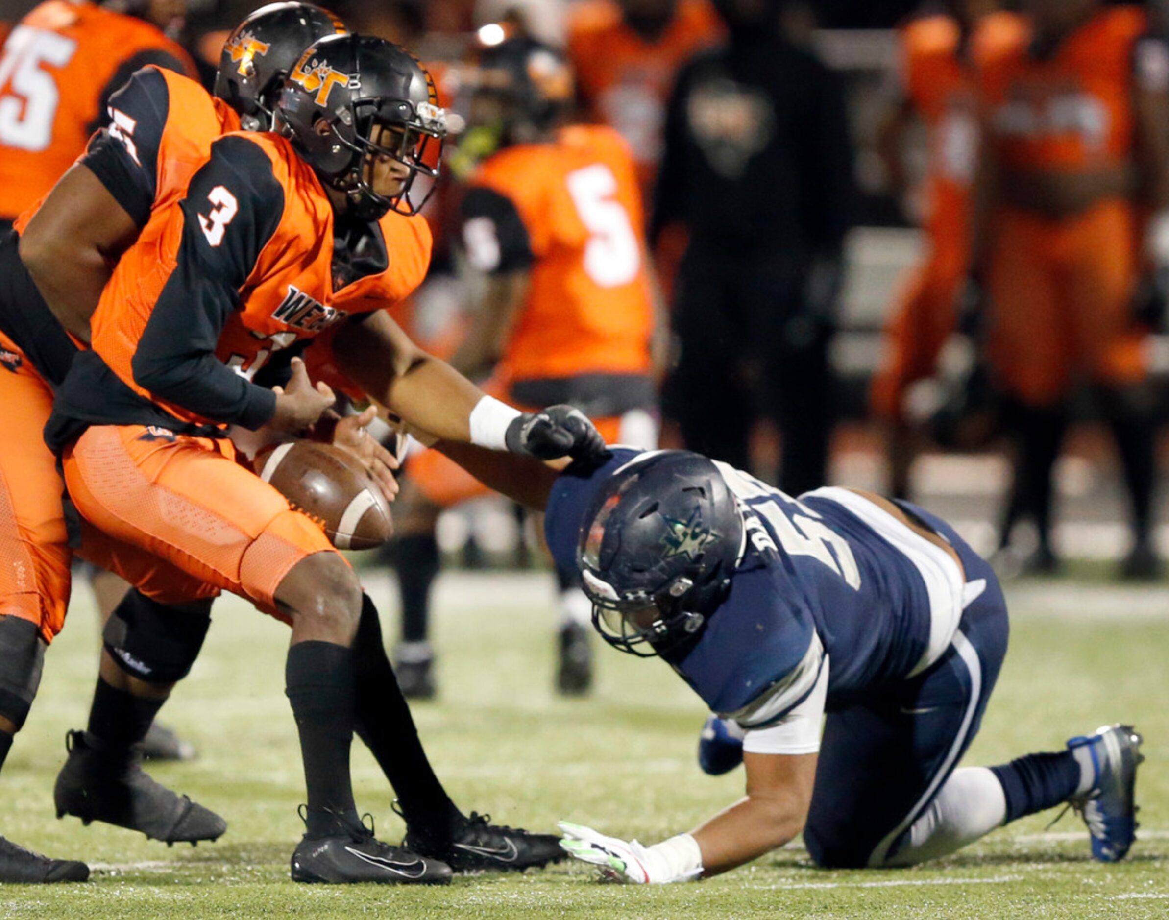 Frisco Lone Star defensive lineman Devin Dawson (57) forces Lancaster quarterback Glenn Rice...