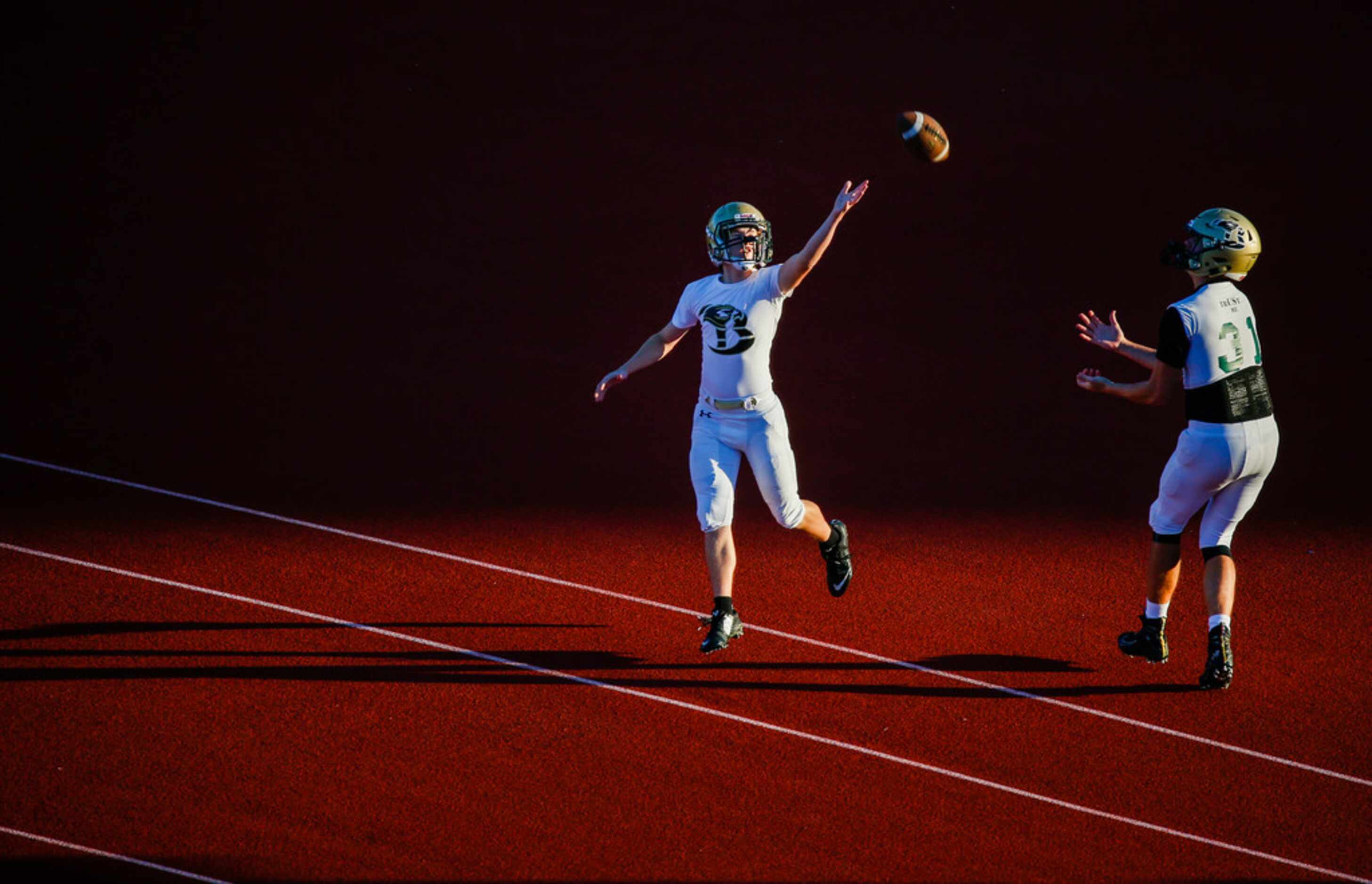 Birdville players warm up prior to a high school football game between Colleyville Heritage...