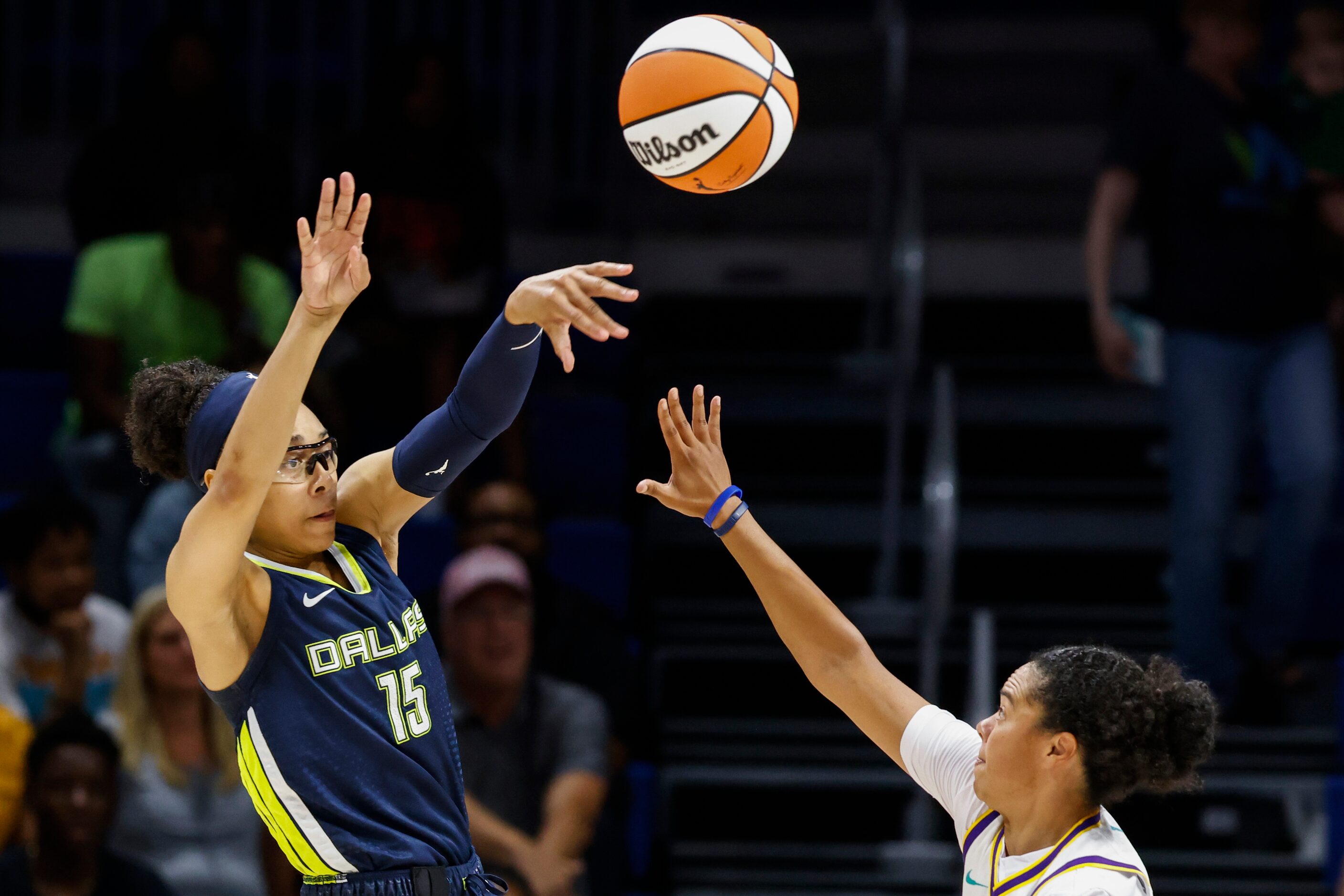 Dallas Wings guard Allisha Gray, left, passes the ball past Los Angeles Sparks guard Kristi...