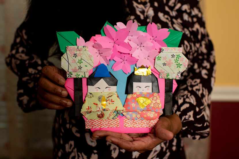 Jayashree Krishnan holds origami that she created at her home in Irving.