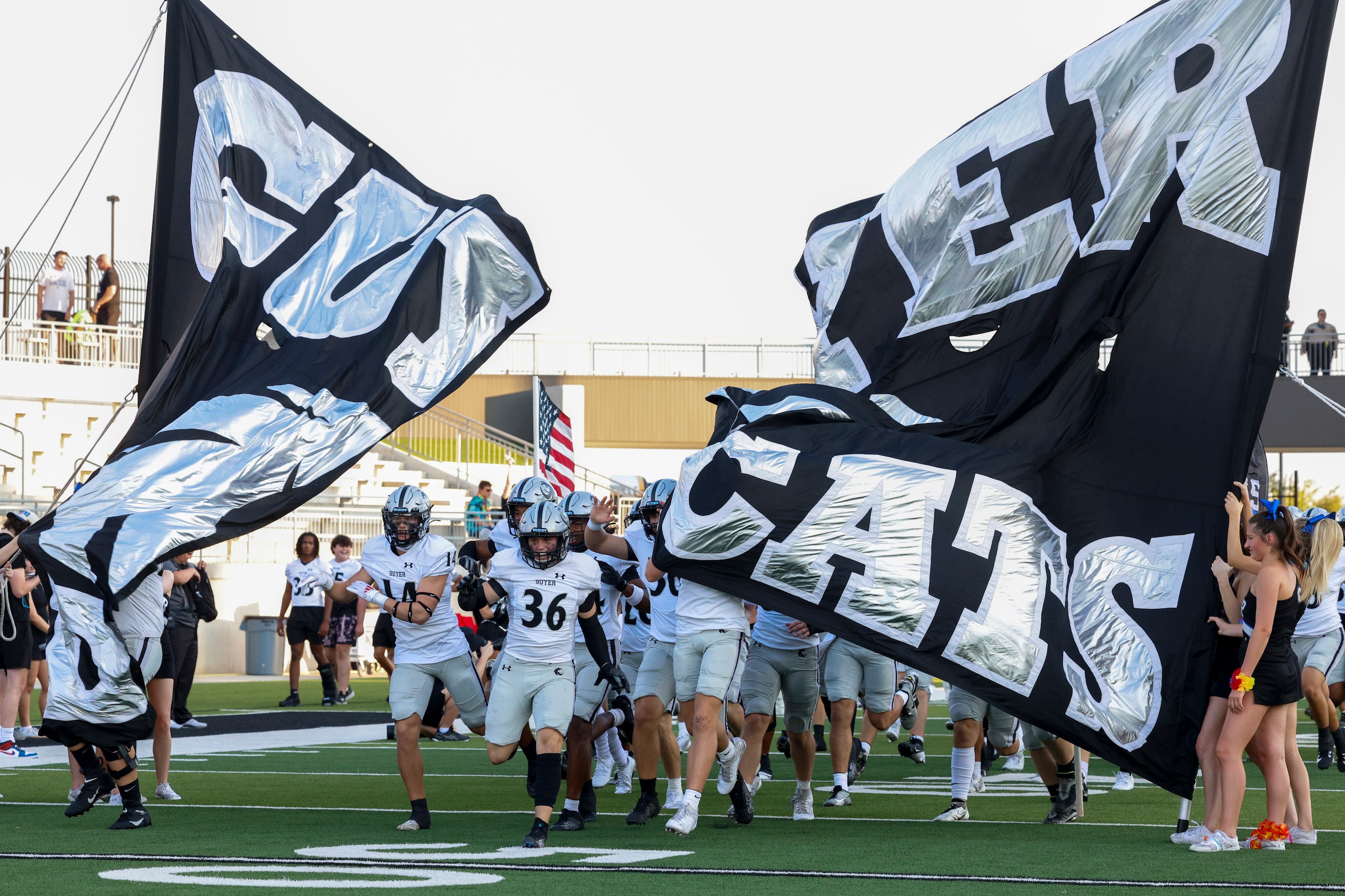 The Denton Guyer football team takes the field before the first half of a non-district high...