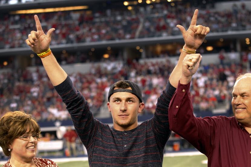  Former Texas A&M Aggies quarterback Johnny Manziel acknowledges the crowd after receiving...