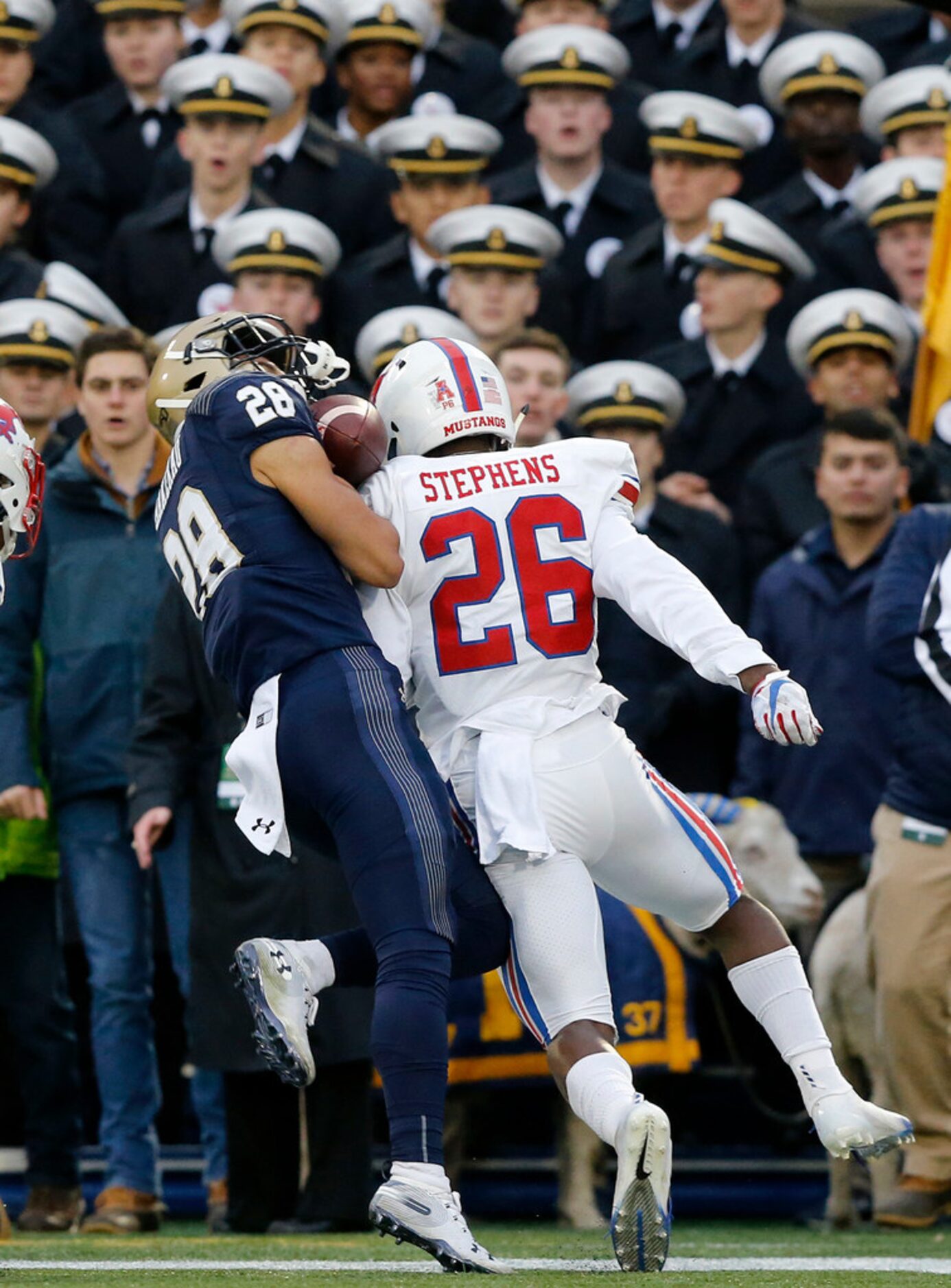 Southern Methodist Mustangs defensive back Brandon Stephens (26) puts a hard hit in Navy...