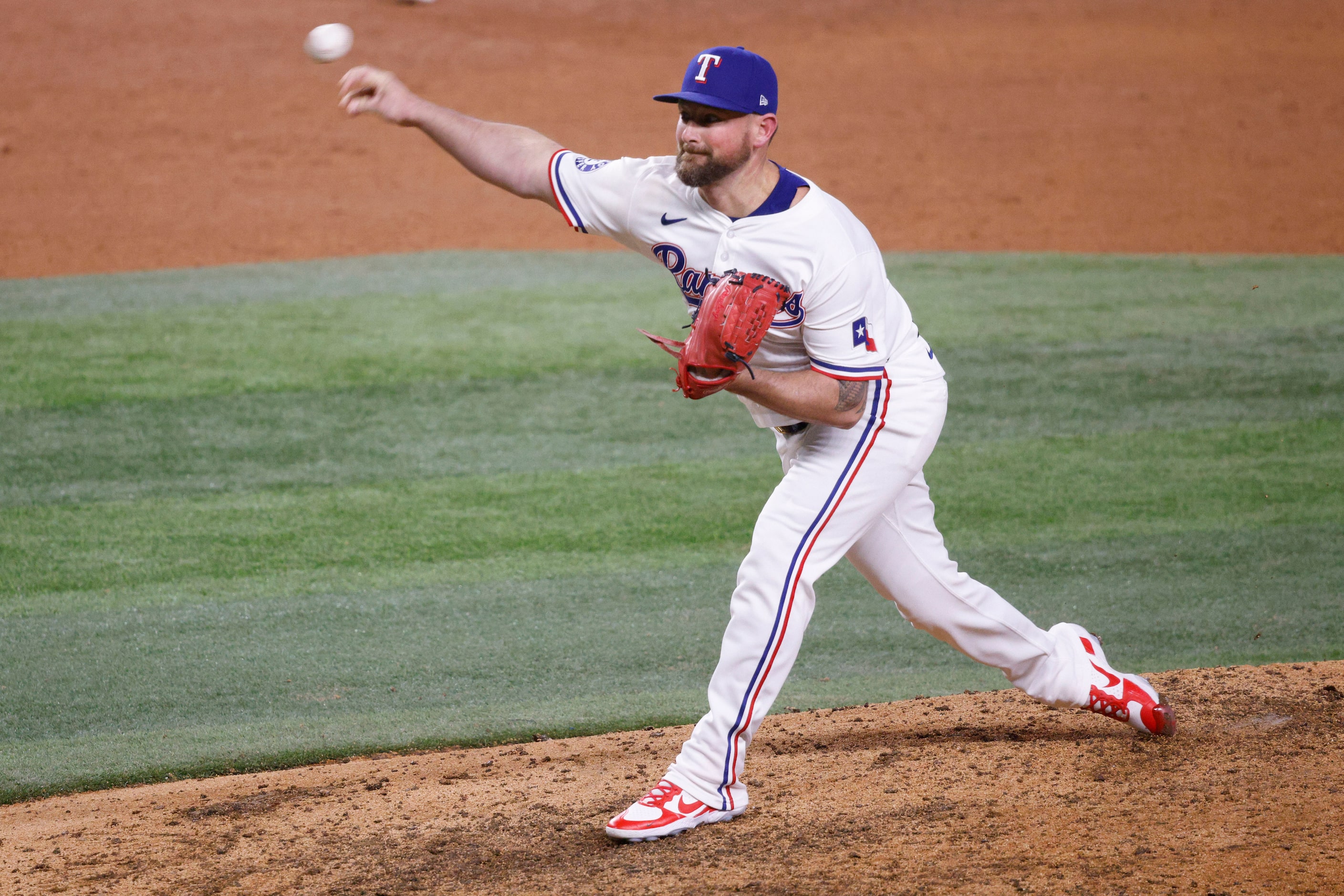 Texas Rangers pitcher Kirby Yates (39) delivers during the ninth inning of a baseball game...