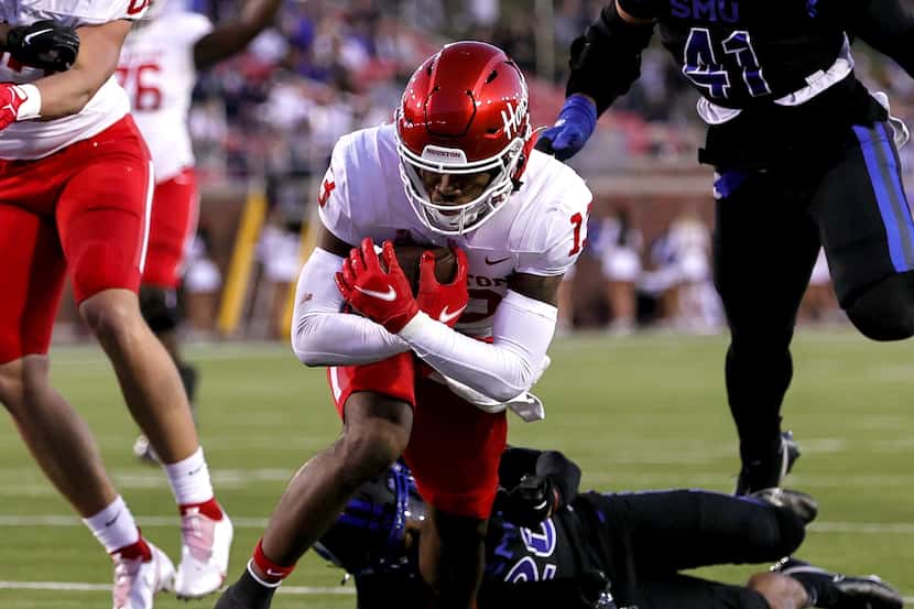 Houston wide receiver Samuel Brown (13) fights his way into the endzone for a 12 yard...