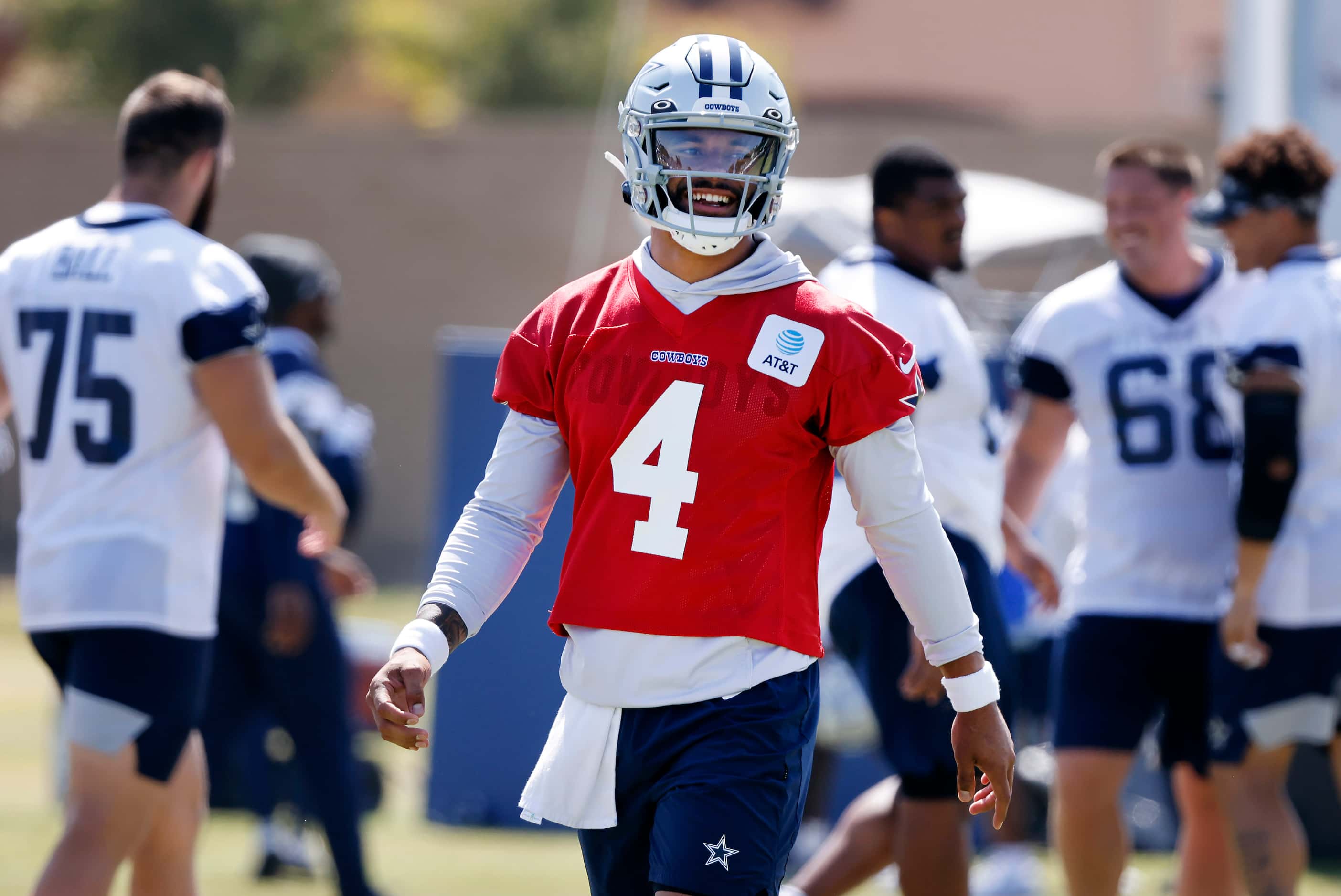 Dallas Cowboys quarterback Dak Prescott (4) smiles as he comes off the field during a mock...