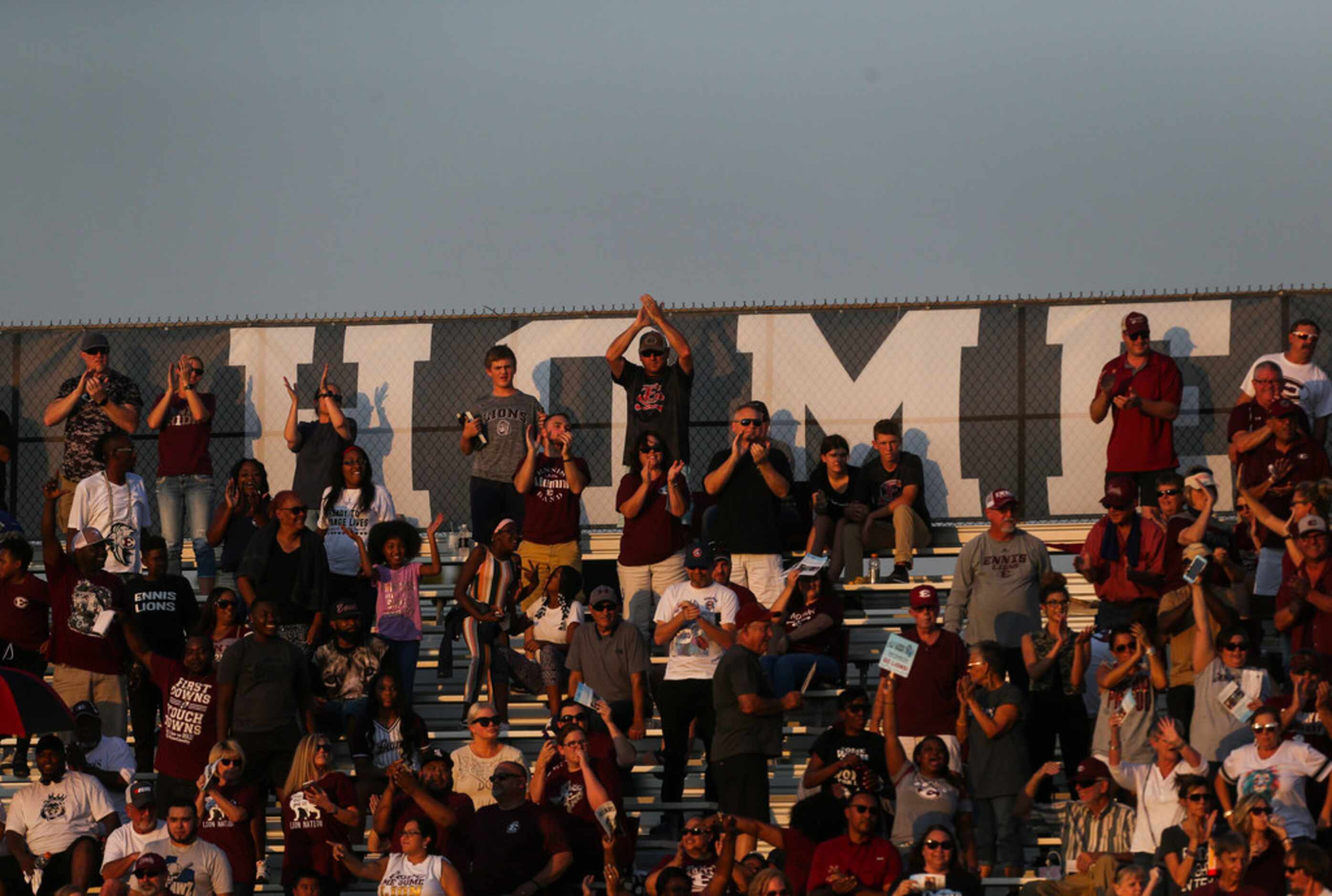Ennis fans cheer after a touchdown during a high school football game between Bishop Lynch...