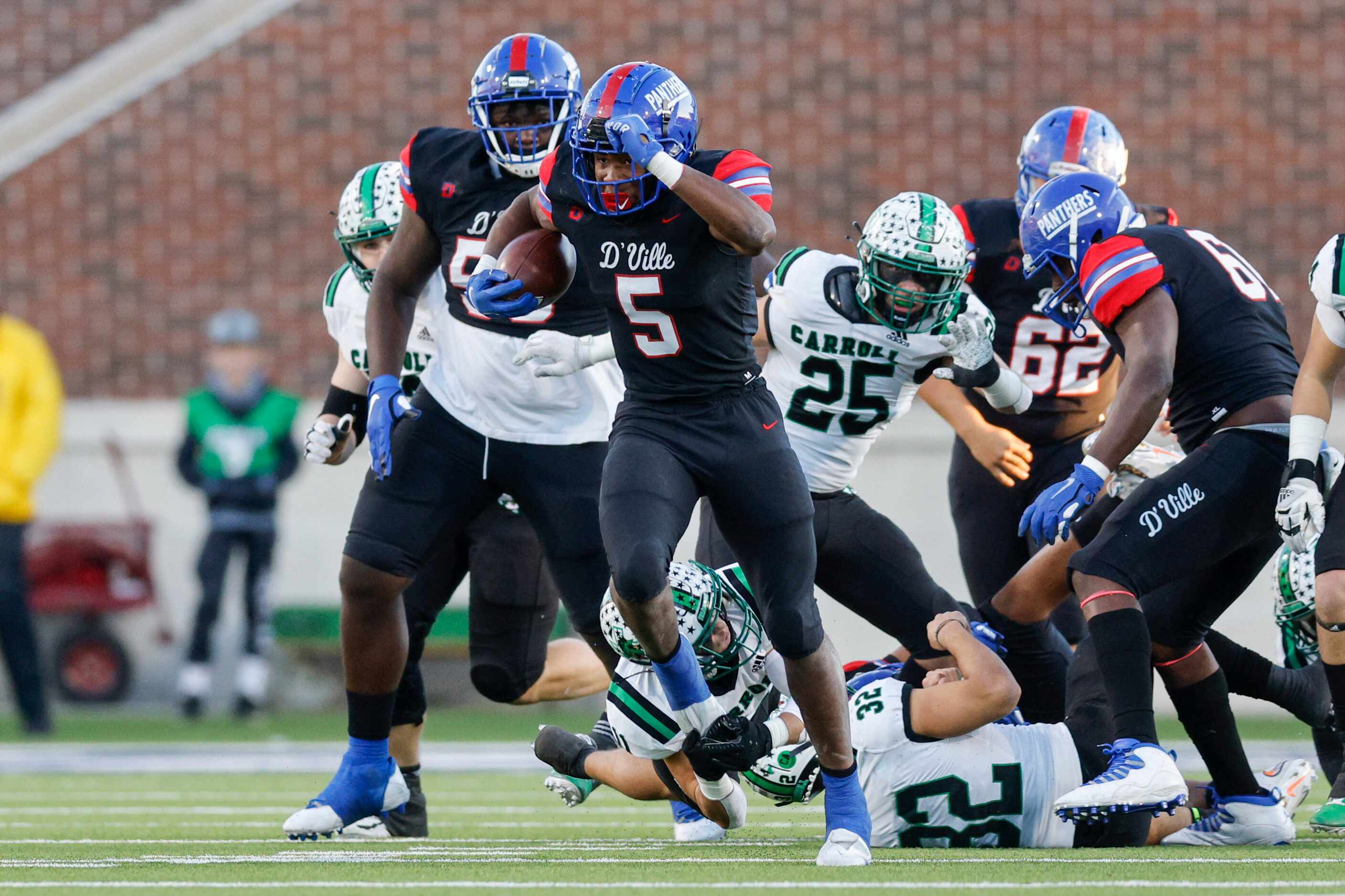 Duncanville running back Malachi Medlock (5) breaks through the line during the first half...