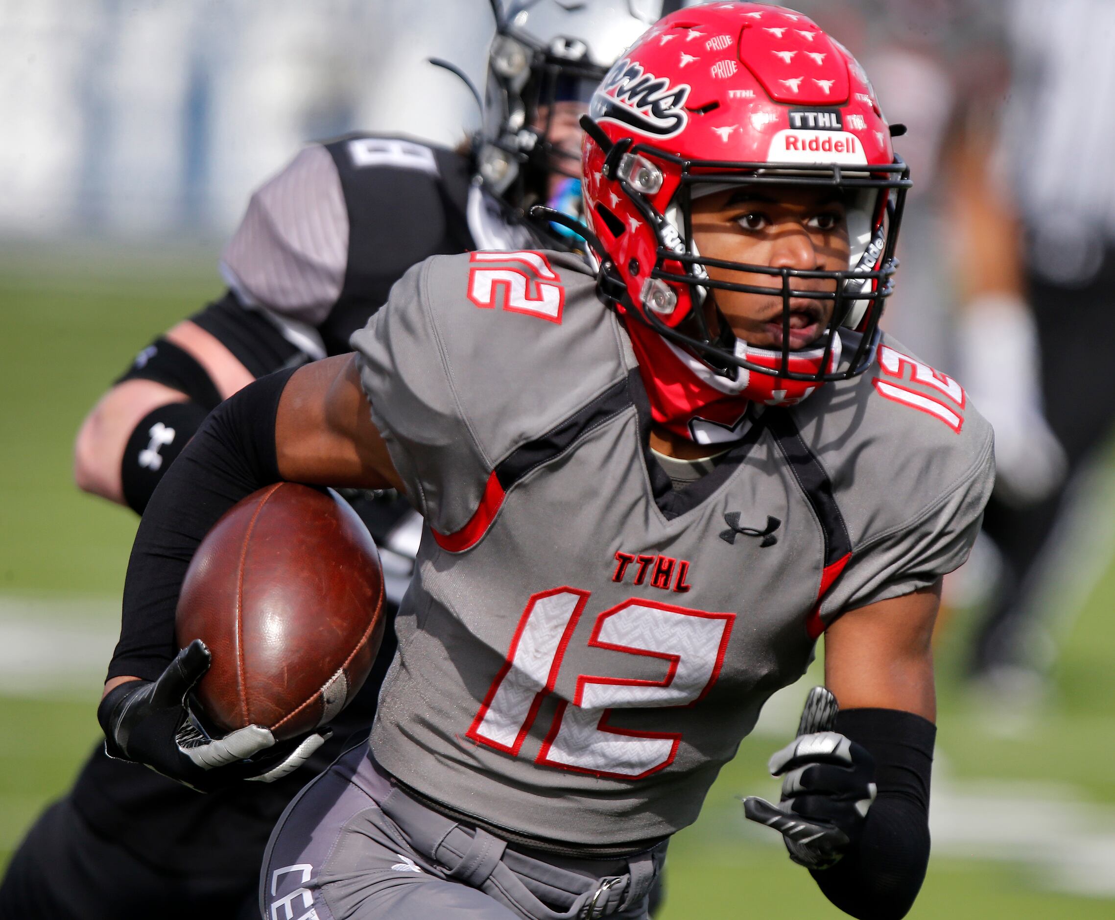 Cedar Hill High School wide receiver Brian Rainey (12) makes a run after the catch in front...