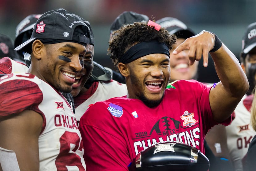 Oklahoma Sooners quarterback Kyler Murray (1) holds up upside down horns after receiving the...