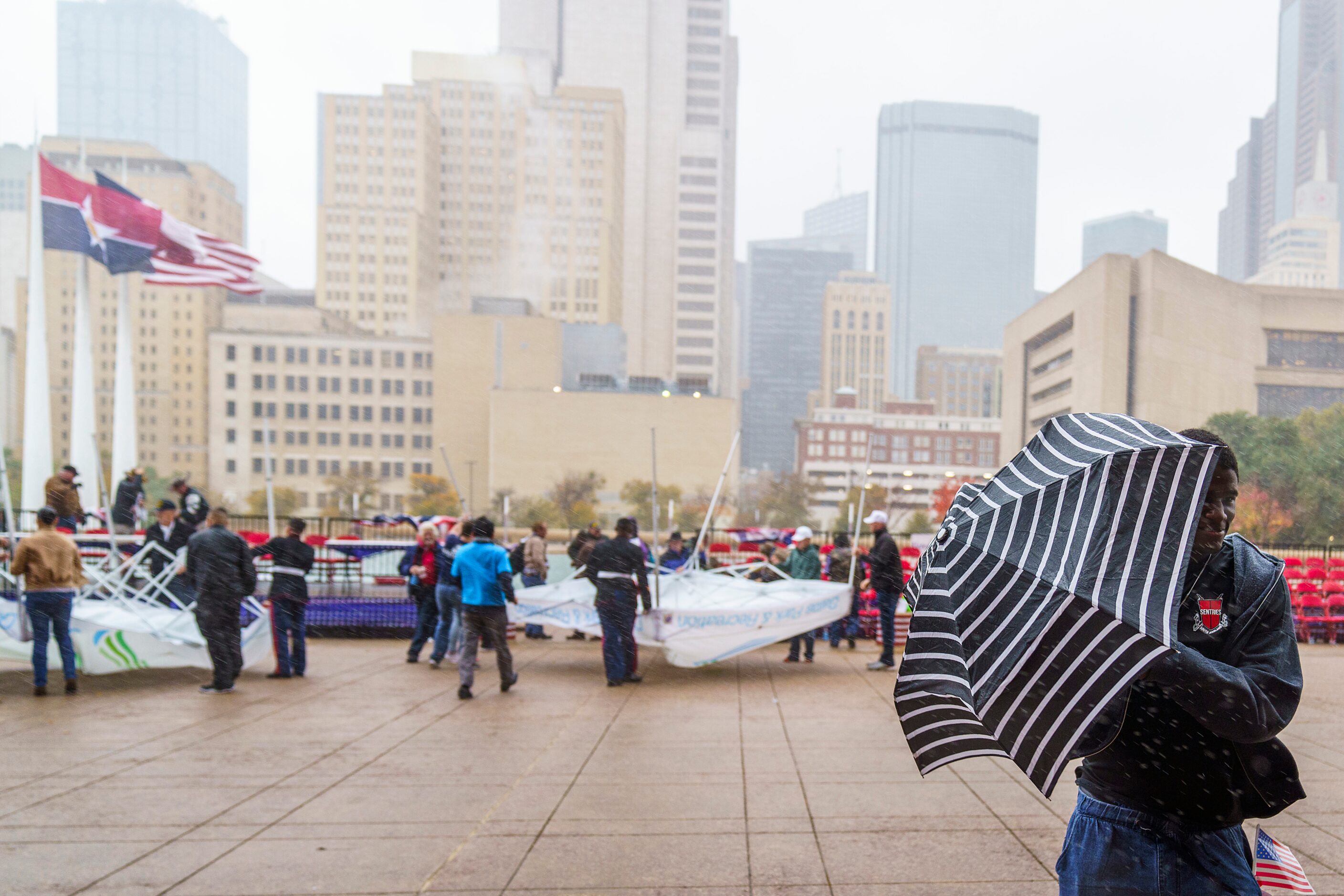 Spectators run for cover as a strong wind turns over a Dallas Parks and Recreation...