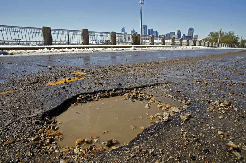 A pothole along Malcolm X Blvd on Thursday, March 5, 2015 in Dallas,Texas. The snow storm...