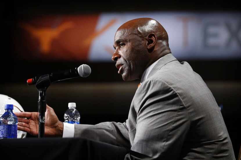 Texas head football coach Charlie Strong responds to questions from reporter assembled...
