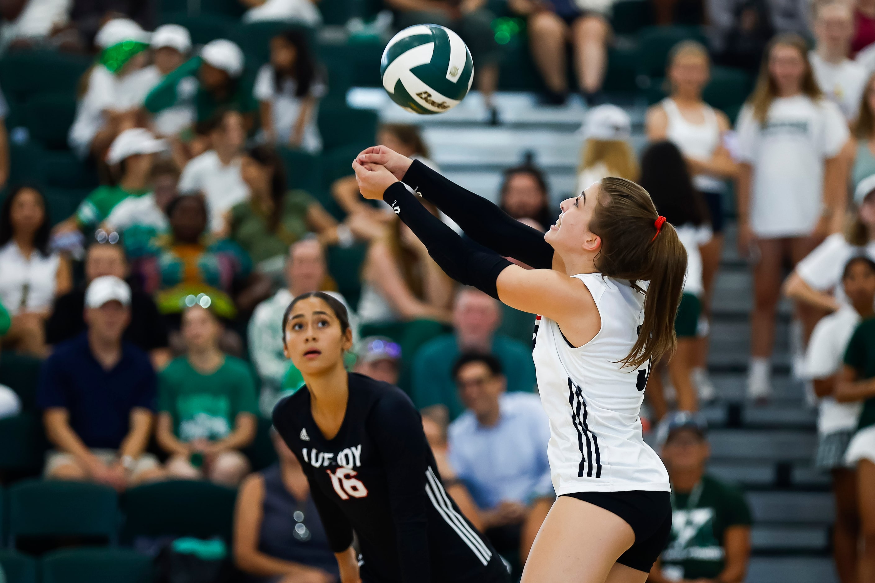 Love Joy senior libero McKenna Brand digs the ball during a high school volleyball match...