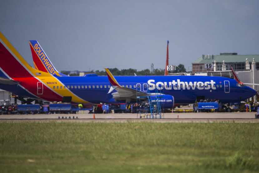 Southwest Airlines airplanes are parked at terminals while computer systems recover on...