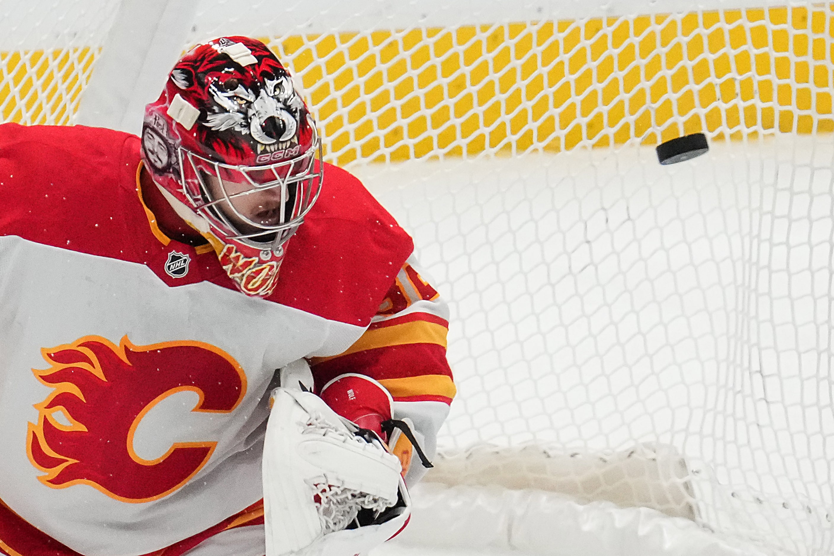 A shot by Dallas Stars defenseman Thomas Harley gets past Calgary Flames goaltender Dustin...